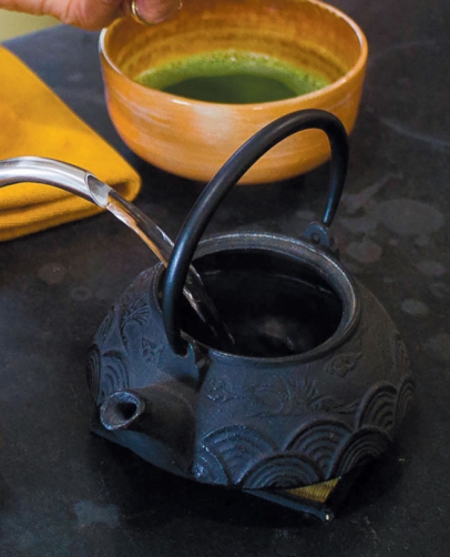 pour matcha green tea from a teapot into a cup